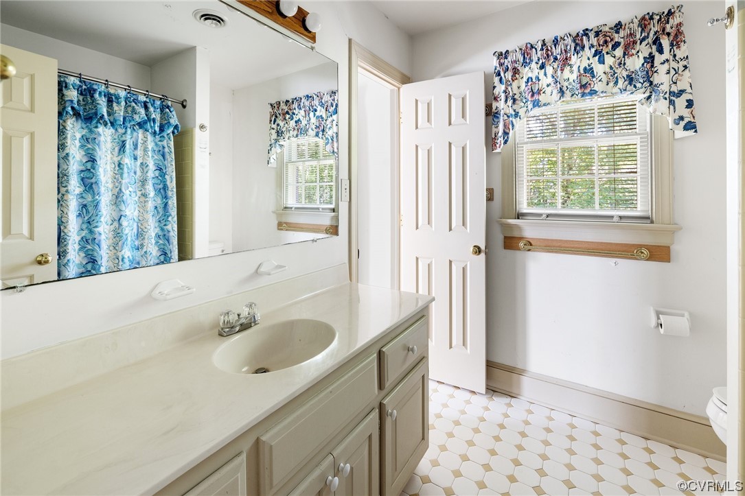 1806 Plain View Road Henrico, VA 23238 - Photo 28 of 33 a bathroom with a sink a mirror and a shower