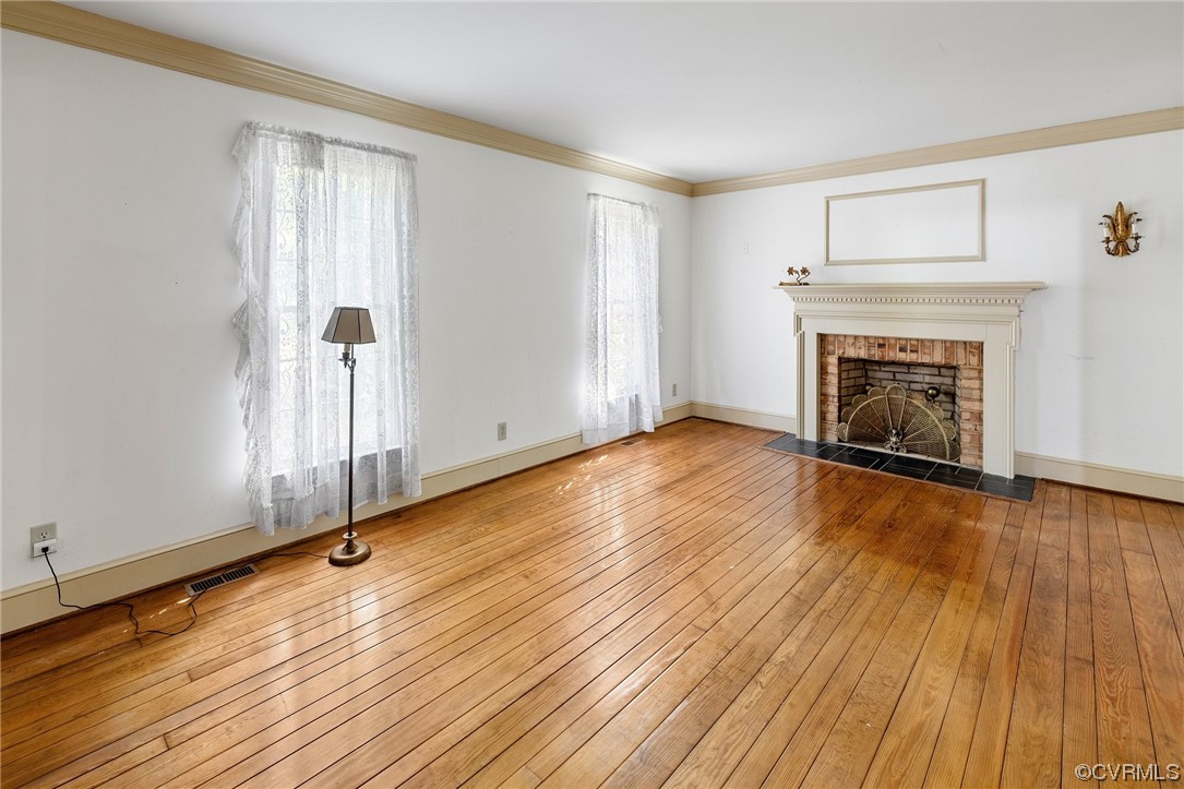 1806 Plain View Road Henrico, VA 23238 - Photo 7 of 33 an empty room with wooden floor fireplace and windows