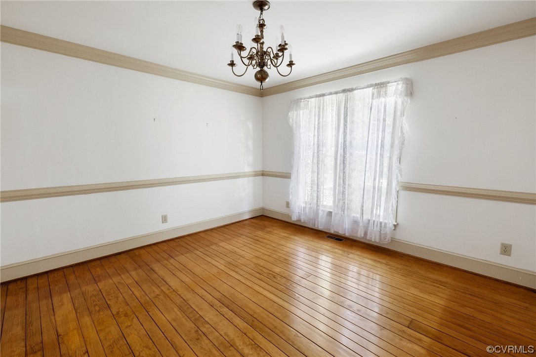 1806 Plain View Road Henrico, VA 23238 - Photo 10 of 33 a view of an empty room with wooden floor and a window
