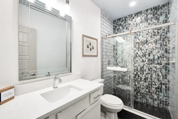 a bathroom with a tub sink and mirror