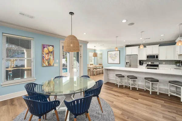 a large kitchen with kitchen island a table and chairs in it