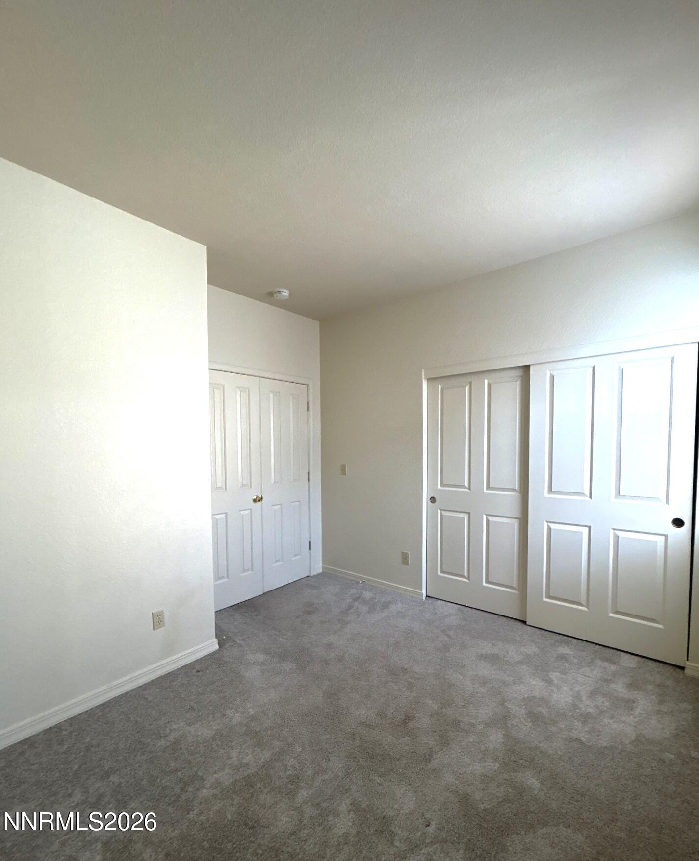 3951 Aspendale Drive Reno, NV 89503 - Photo 20 of 22 an empty room with a cabinet and mirrors