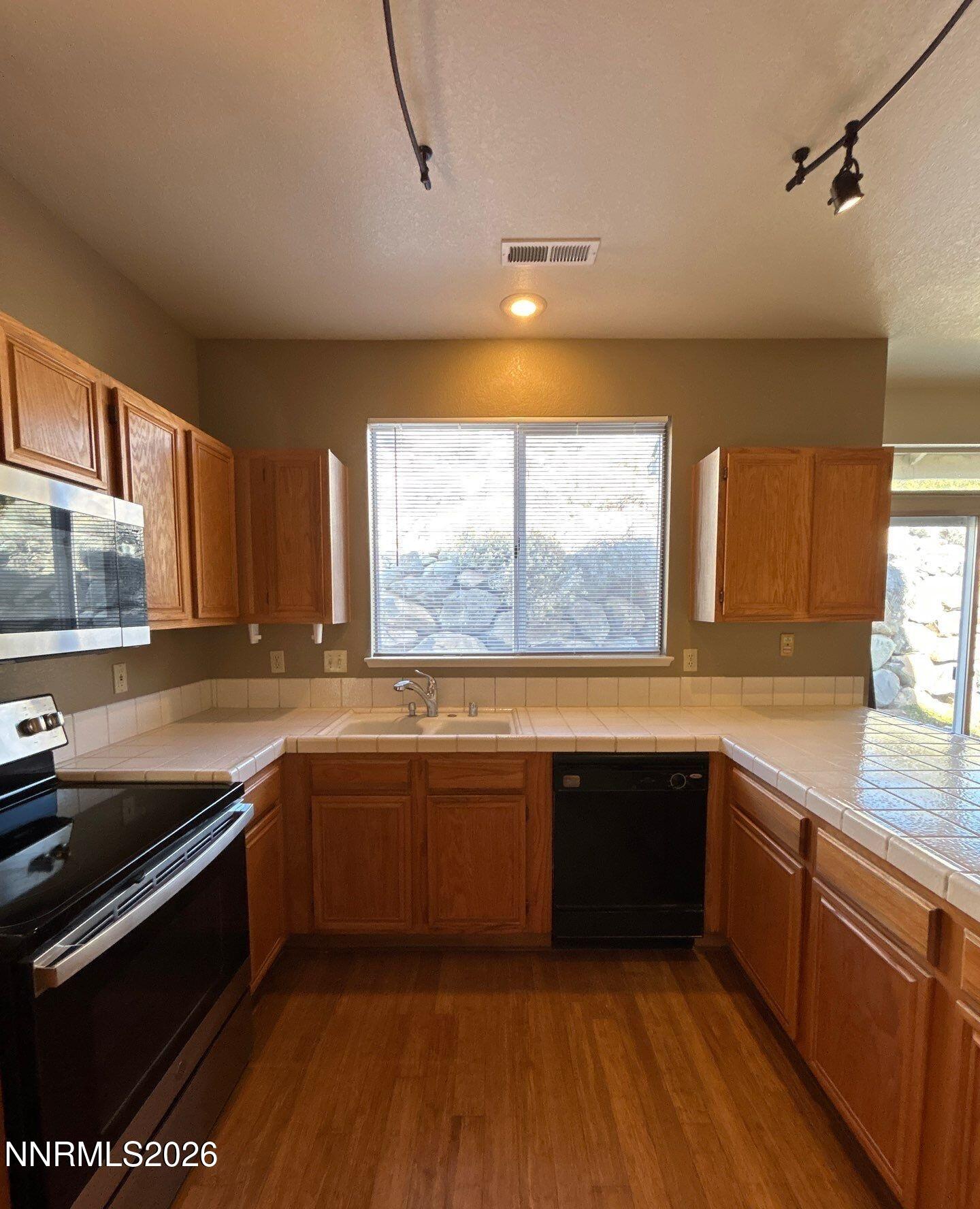 3951 Aspendale Drive Reno, NV 89503 - Photo 5 of 22 a kitchen with stainless steel appliances granite countertop sink stove and cabinets