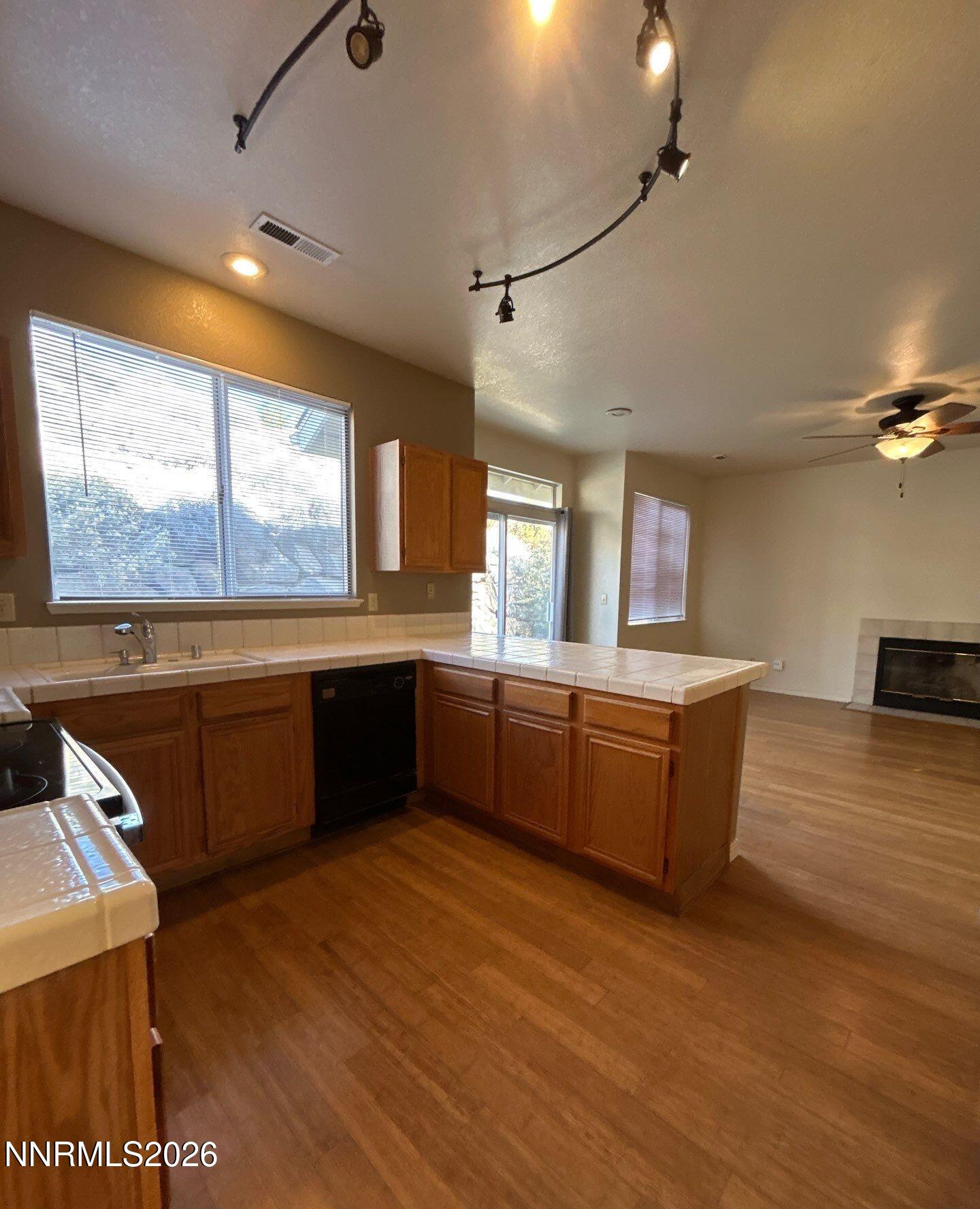 3951 Aspendale Drive Reno, NV 89503 - Photo 6 of 22 a kitchen with stainless steel appliances kitchen island granite countertop a stove a sink and a microwave