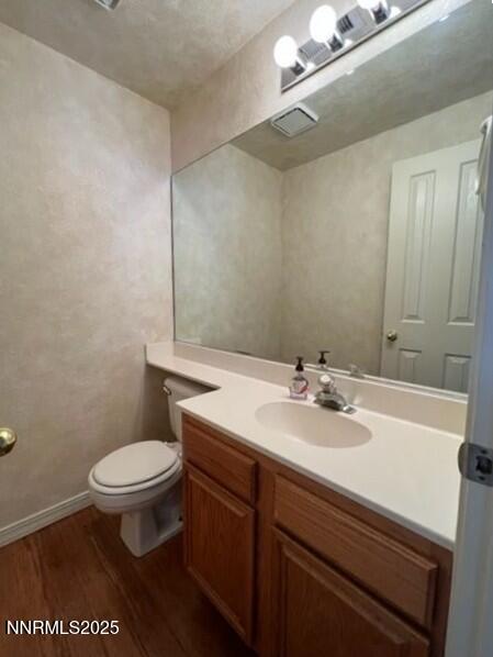 3951 Aspendale Drive Reno, NV 89503 - Photo 9 of 22 a bathroom with a sink a toilet a mirror and vanity