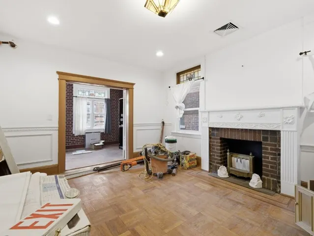 a living room with furniture and a fireplace