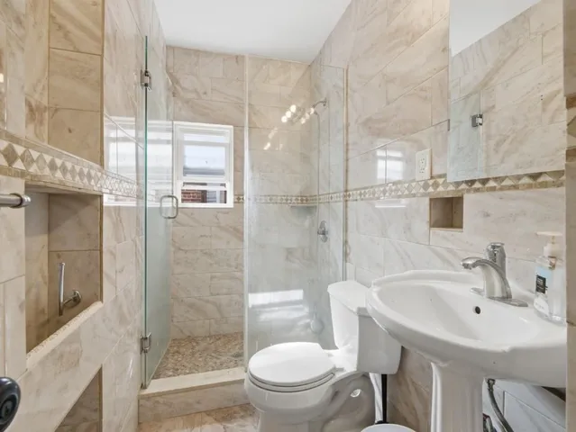 a bathroom with a sink toilet and shower