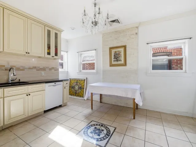 a spacious en suite bathroom with a mirror and a bathtub