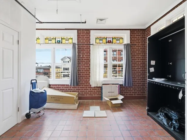 a living room with furniture a flat screen tv and gym equipment