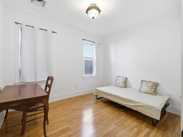 a bedroom with a bed and a table in it