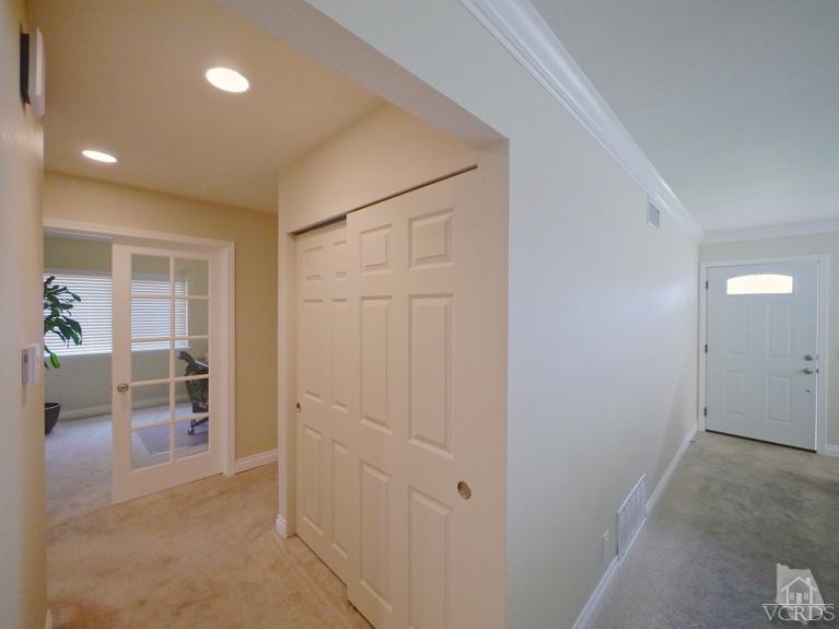 13421 Laurelhurst Road Moorpark, CA 93021 - Photo 11 of 28 an empty room with wooden floor and a corridor