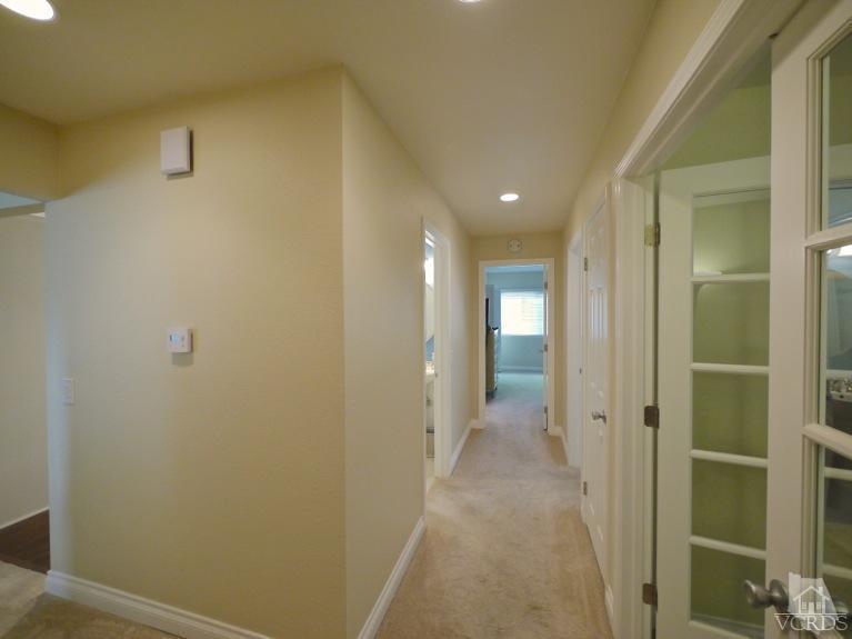13421 Laurelhurst Road Moorpark, CA 93021 - Photo 14 of 28 a view of a hallway with wooden shelves