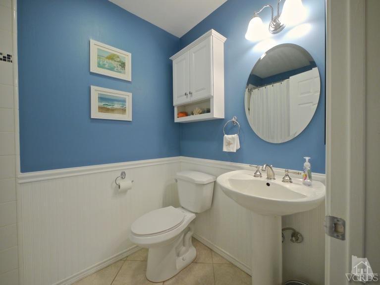 13421 Laurelhurst Road Moorpark, CA 93021 - Photo 15 of 28 a bathroom with a sink mirror and toilet