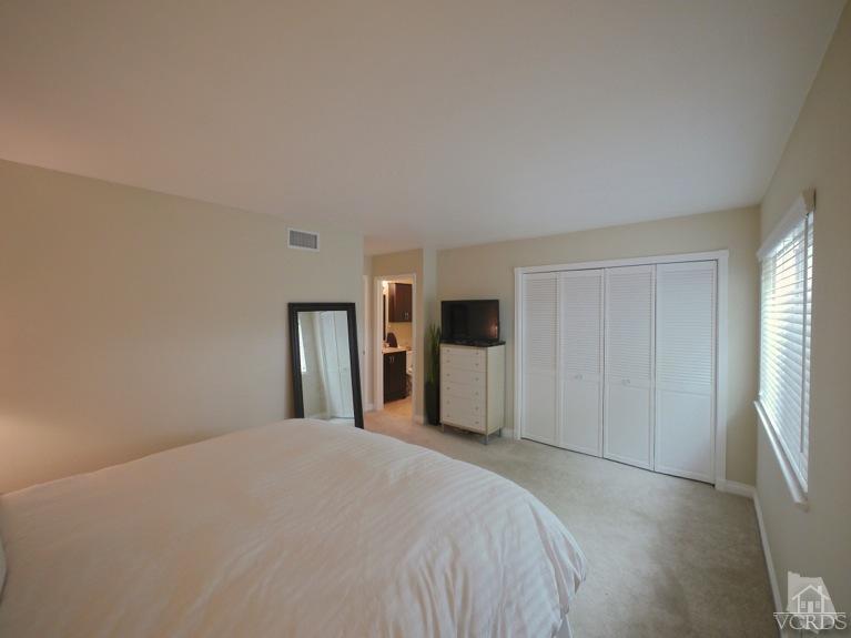 13421 Laurelhurst Road Moorpark, CA 93021 - Photo 20 of 28 a bedroom with a bed and a large mirror
