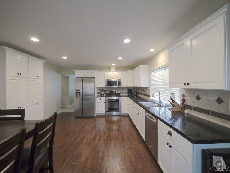 13421 Laurelhurst Road Moorpark, CA 93021 - Photo 8 of 28 a large kitchen with stainless steel appliances lots of counter space and wooden floor