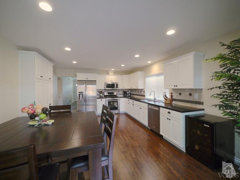 13421 Laurelhurst Road Moorpark, CA 93021 - Photo 9 of 28 a kitchen with counter space dining table and chairs
