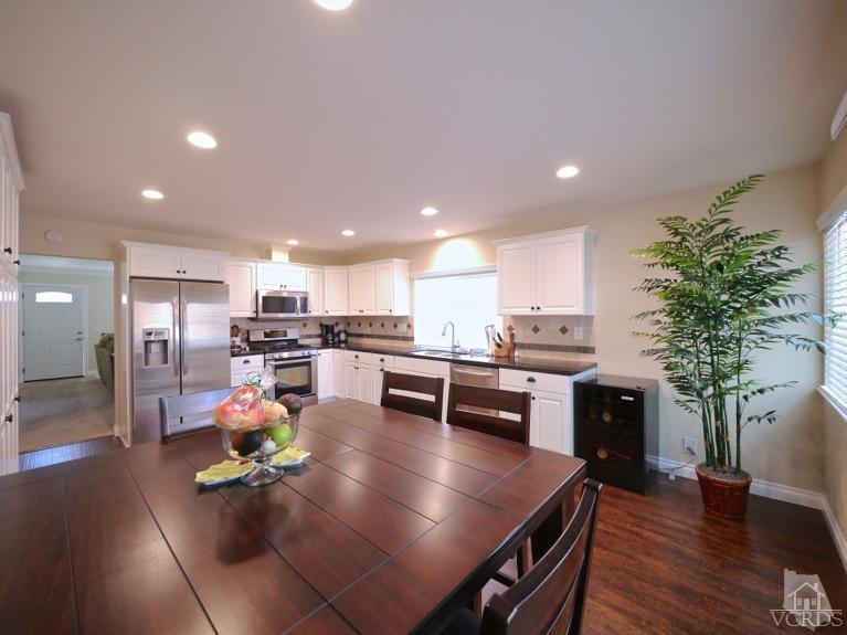 13421 Laurelhurst Road Moorpark, CA 93021 - Photo 10 of 28 a kitchen with sink refrigerator dining table and chairs