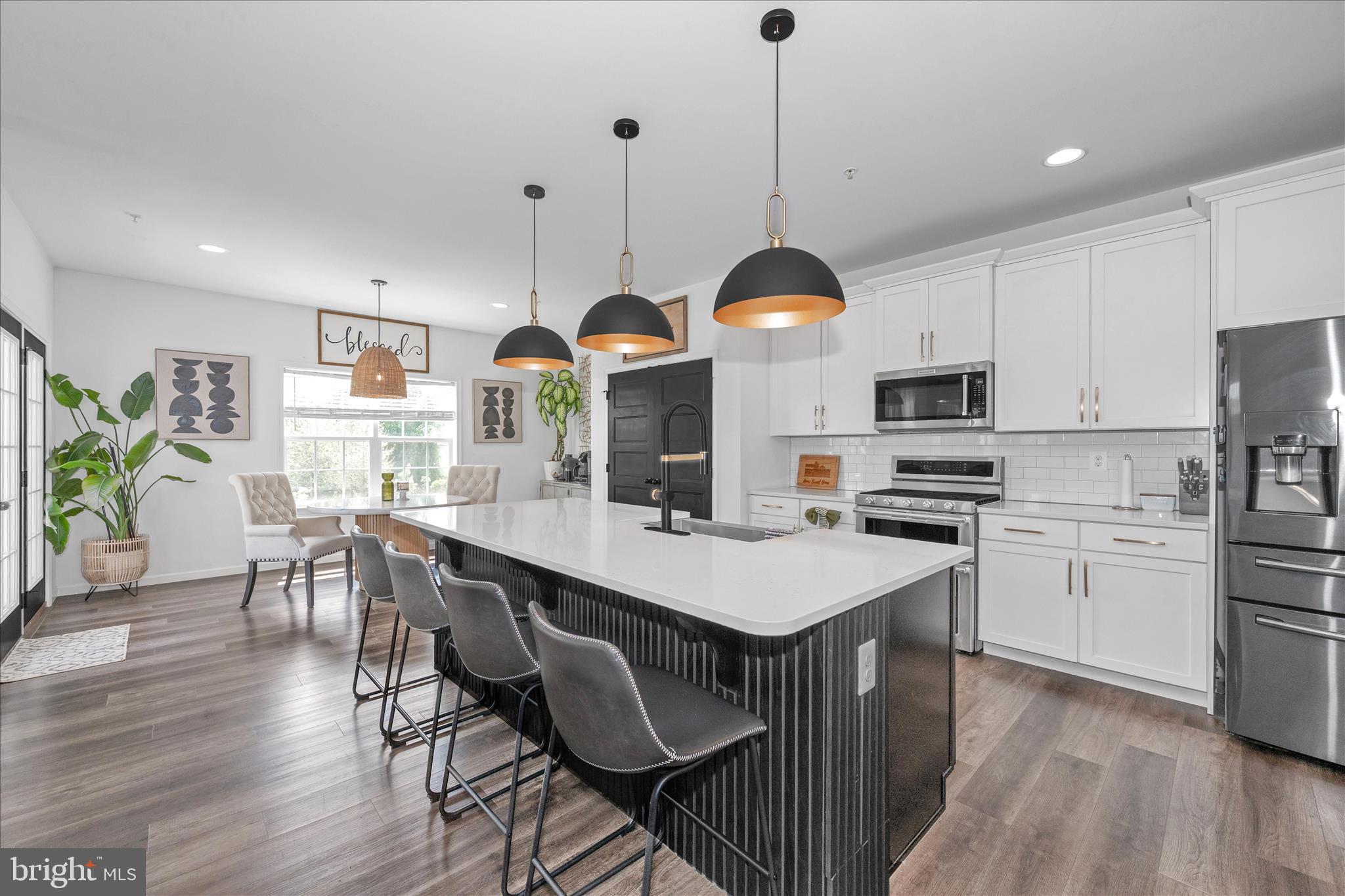 1388 Rocky Springs Road Frederick, MD 21702 - Photo 17 of 97 a kitchen with stainless steel appliances a stove a sink a refrigerator a center island and a wooden floor