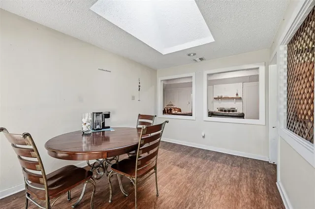 a view of a dining room with furniture and window