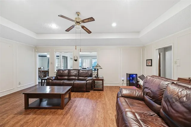 a living room with furniture and a wooden floor