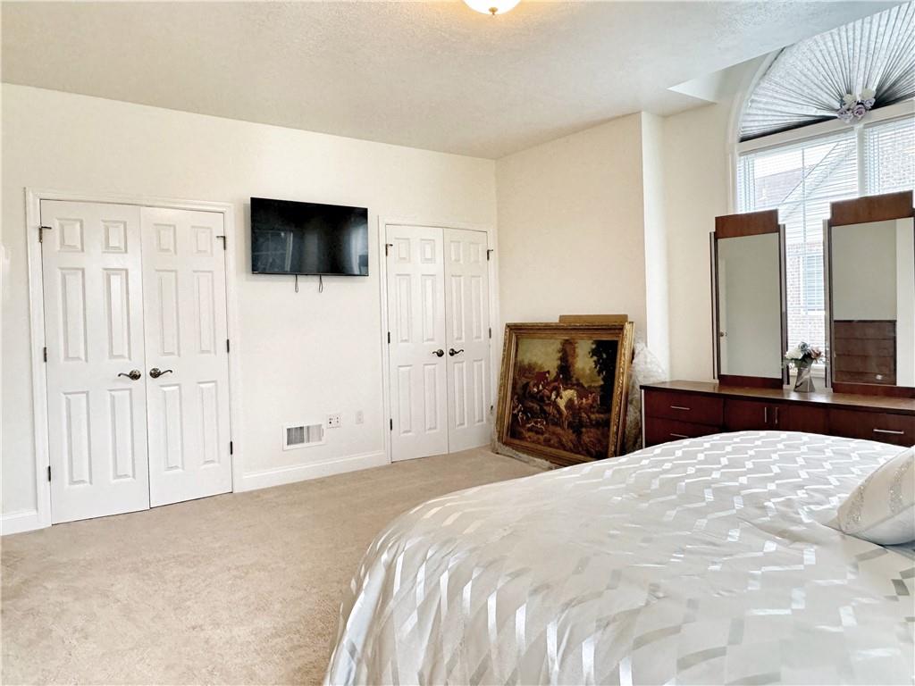 67 Nicholas Drive Beaver, PA 15009 - Photo 13 of 27 a bedroom with a large bed and a flat tv screen