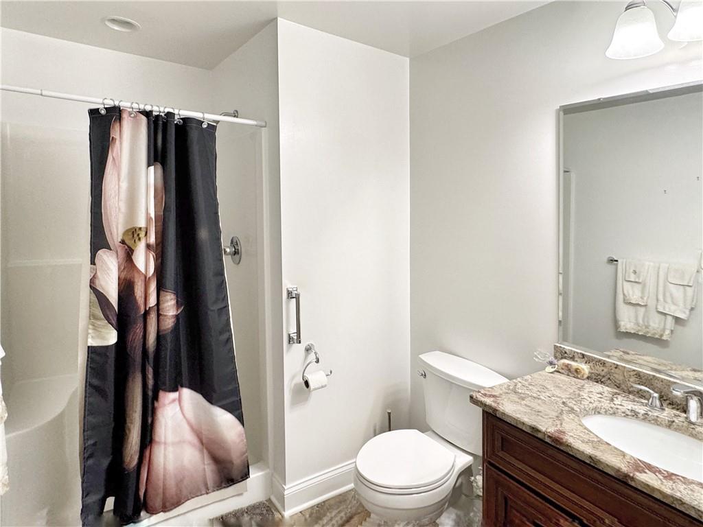 67 Nicholas Drive Beaver, PA 15009 - Photo 19 of 27 a bathroom with a granite countertop toilet sink and shower