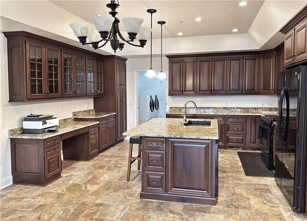 67 Nicholas Drive Beaver, PA 15009 - Photo 7 of 27 a kitchen with a stove kitchen island wooden cabinets and a sink