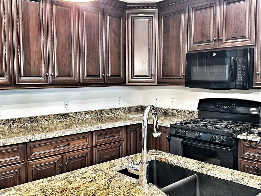 67 Nicholas Drive Beaver, PA 15009 - Photo 9 of 27 a kitchen with granite countertop a sink and a stove