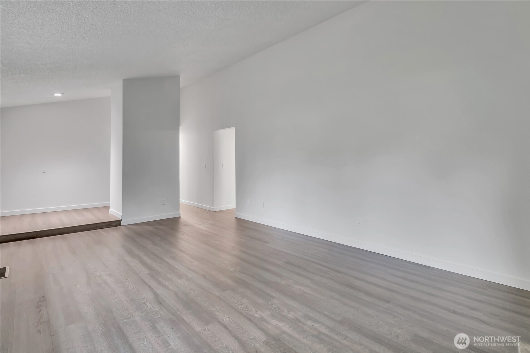 2728 Natalie Lane Steilacoom, WA 98388 - Photo 11 of 23 a view of an empty room with wooden floor and a window