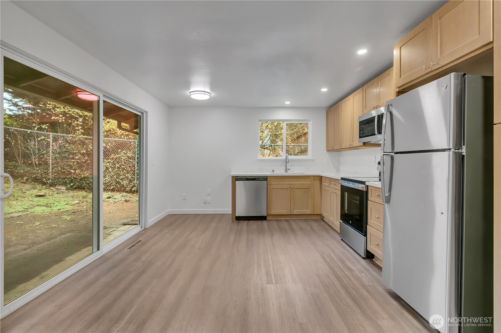 2728 Natalie Lane Steilacoom, WA 98388 - Photo 6 of 23 a kitchen with a refrigerator a sink and a large window
