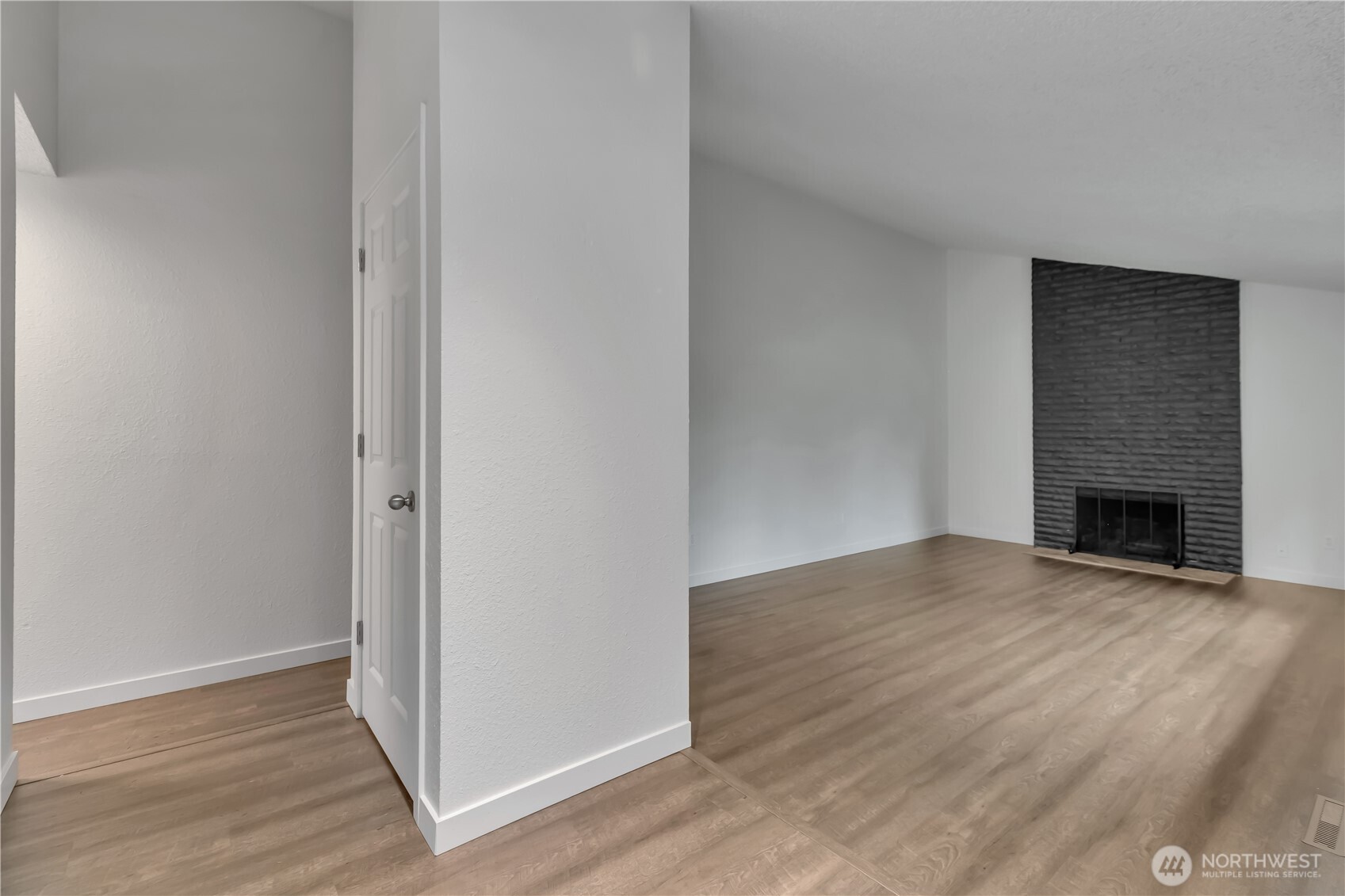 2728 Natalie Lane Steilacoom, WA 98388 - Photo 9 of 23 a view of empty room with wooden floor and fireplace