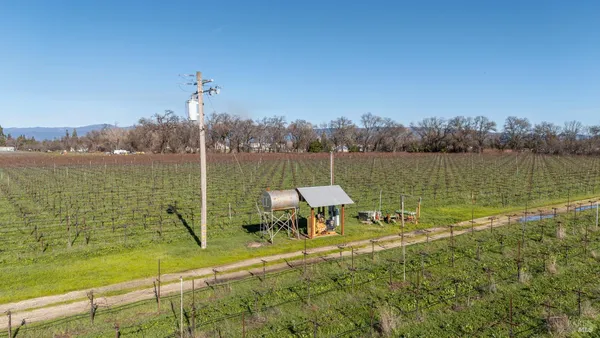 a view of a lake with a table and chairs
