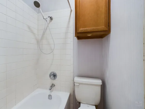 a bathroom with a toilet and a bathtub