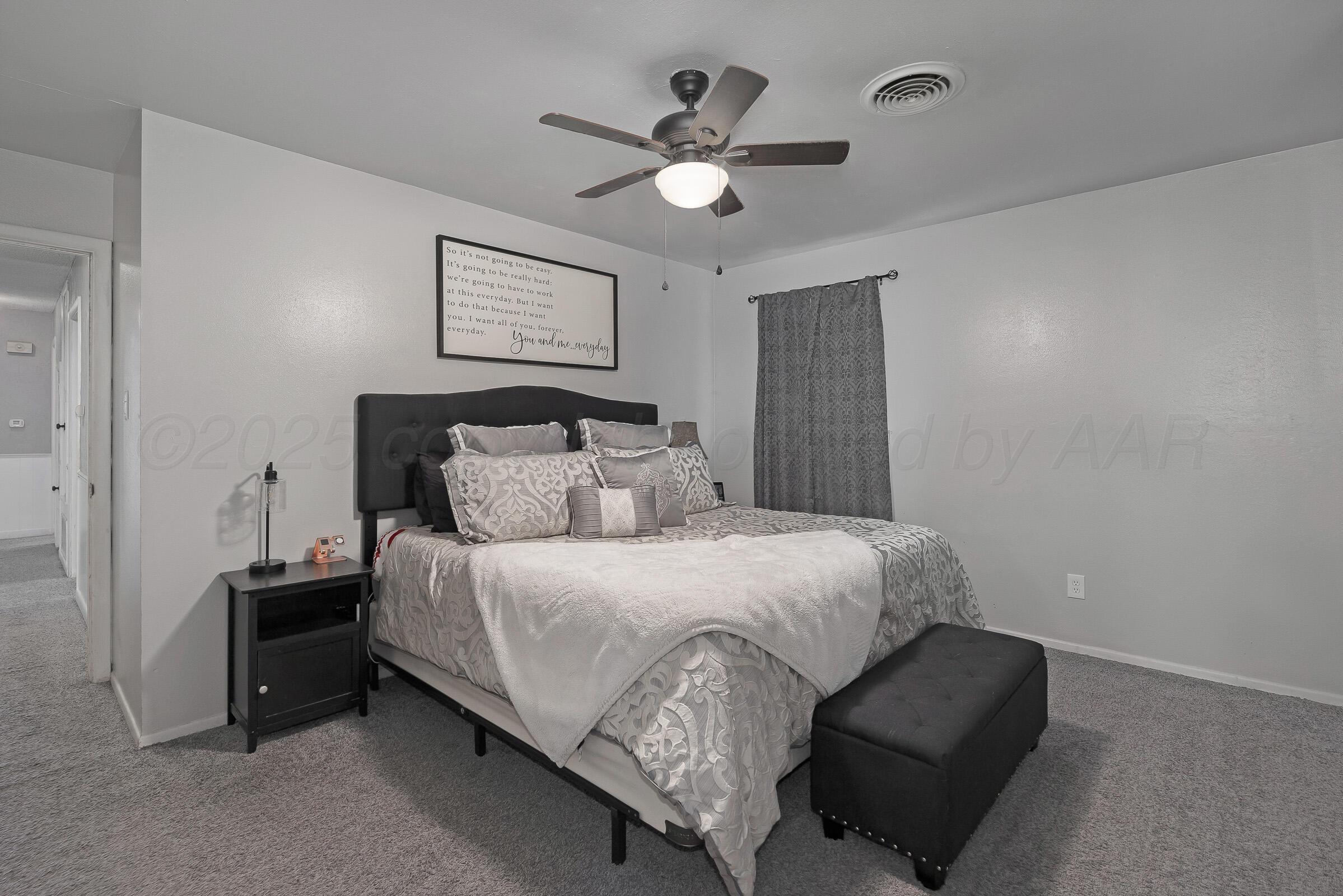4020 Tulane Drive Amarillo, TX 79109 - Photo 13 of 23 a bedroom with bed and a ceiling fan