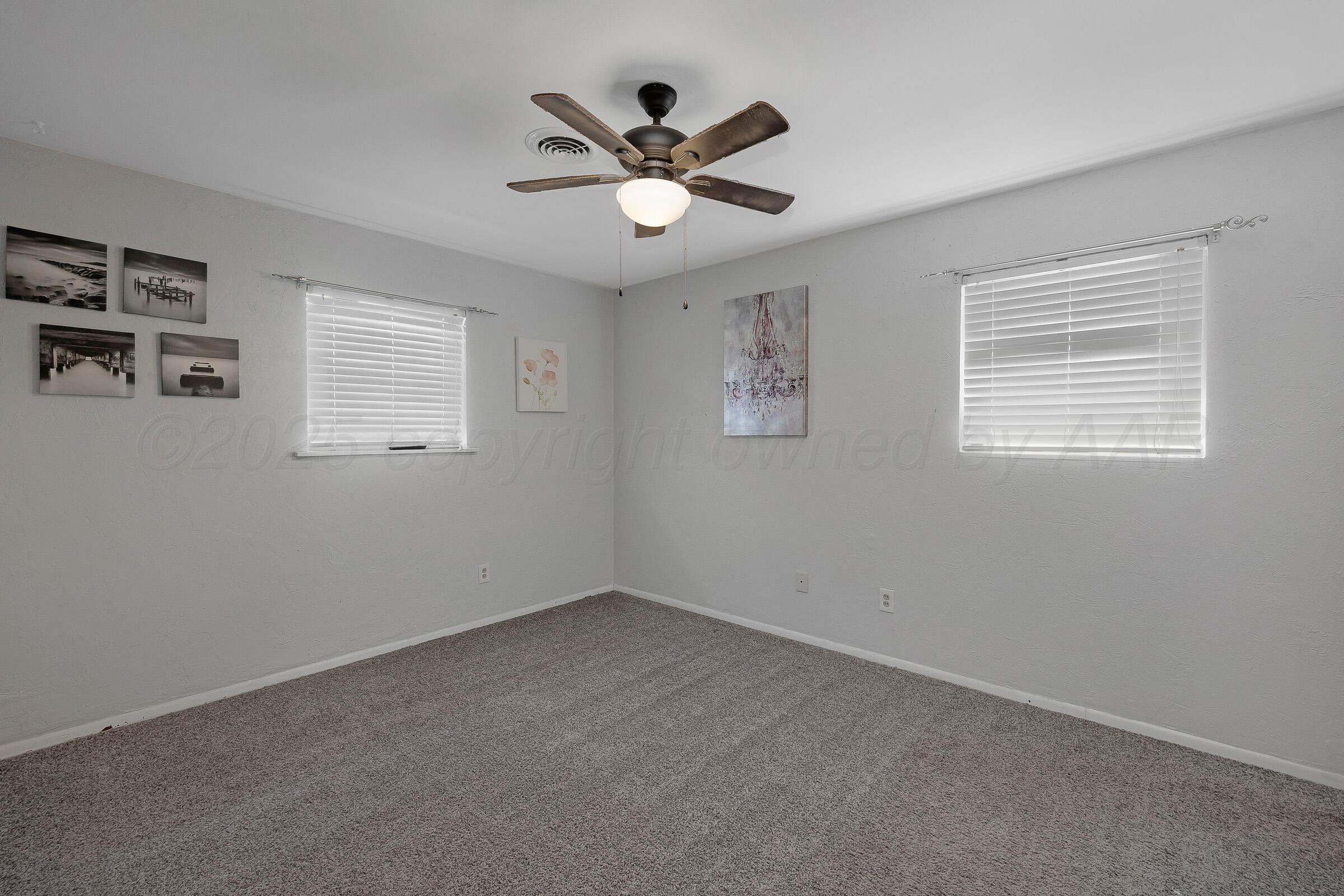 4020 Tulane Drive Amarillo, TX 79109 - Photo 16 of 23 a view of a livingroom with window ceiling fan and wooden floor
