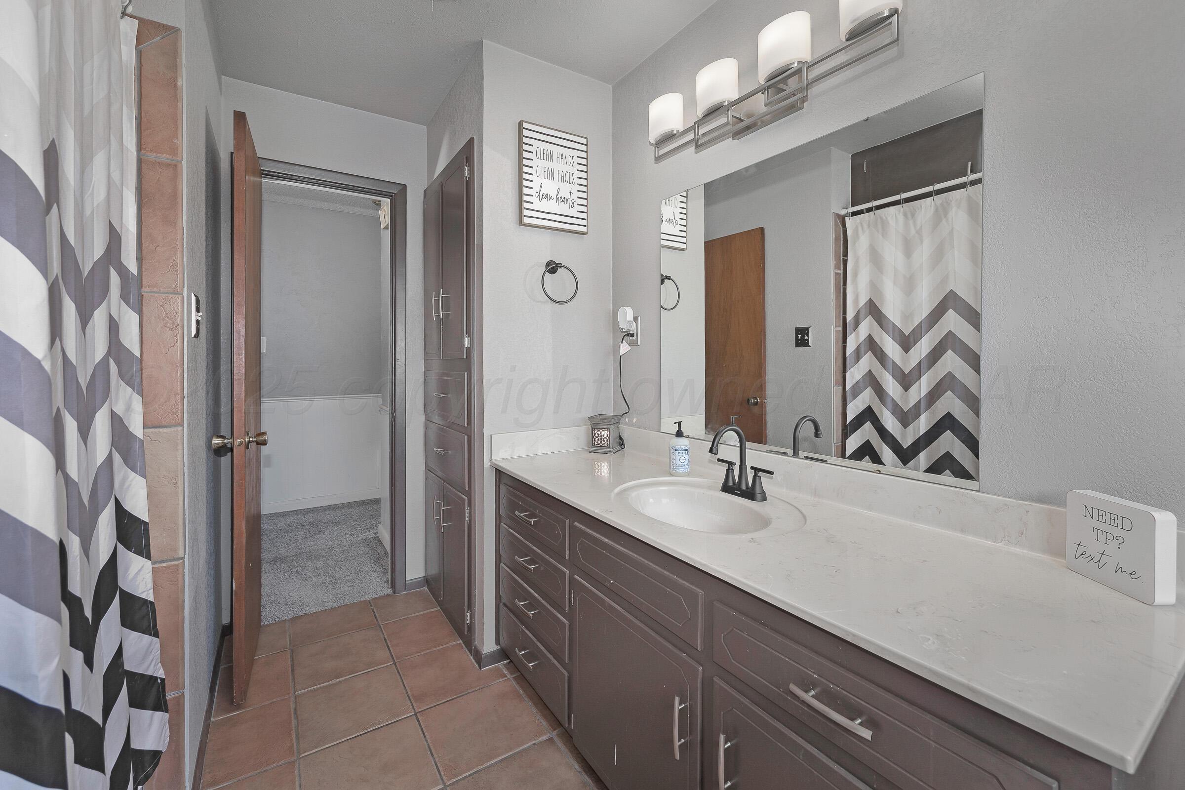 4020 Tulane Drive Amarillo, TX 79109 - Photo 17 of 23 a bathroom with a sink and a mirror