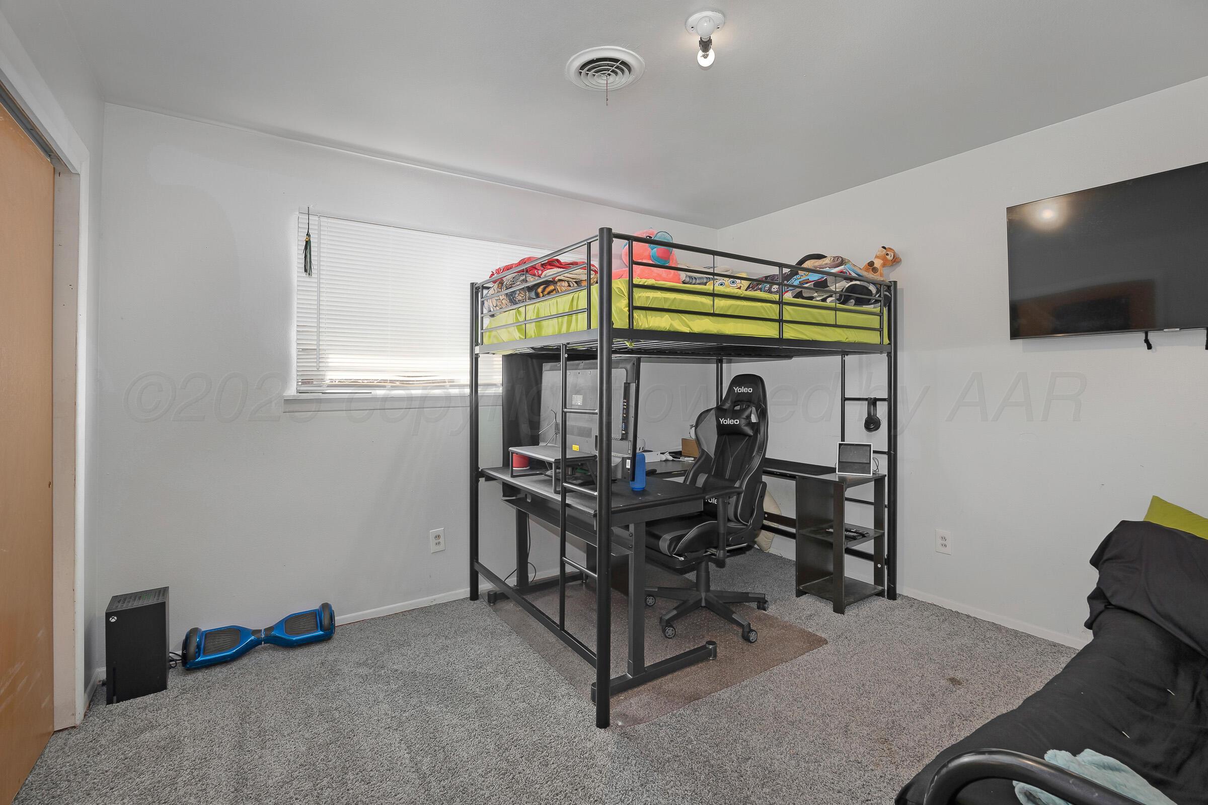 4020 Tulane Drive Amarillo, TX 79109 - Photo 18 of 23 a living room with furniture and a flat screen tv