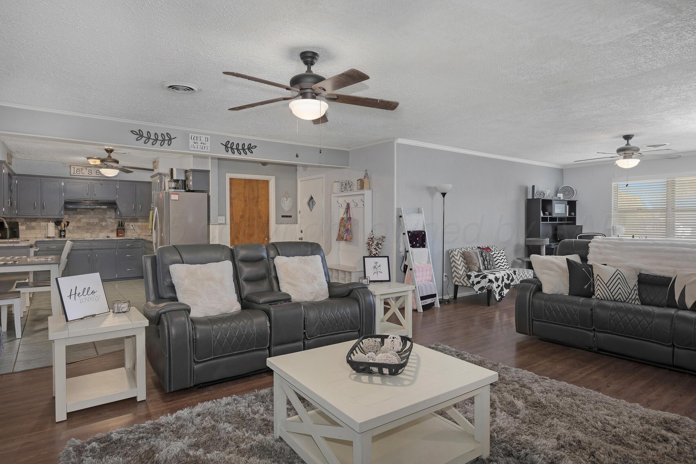 4020 Tulane Drive Amarillo, TX 79109 - Photo 4 of 23 a living room with furniture kitchen view and a chandelier