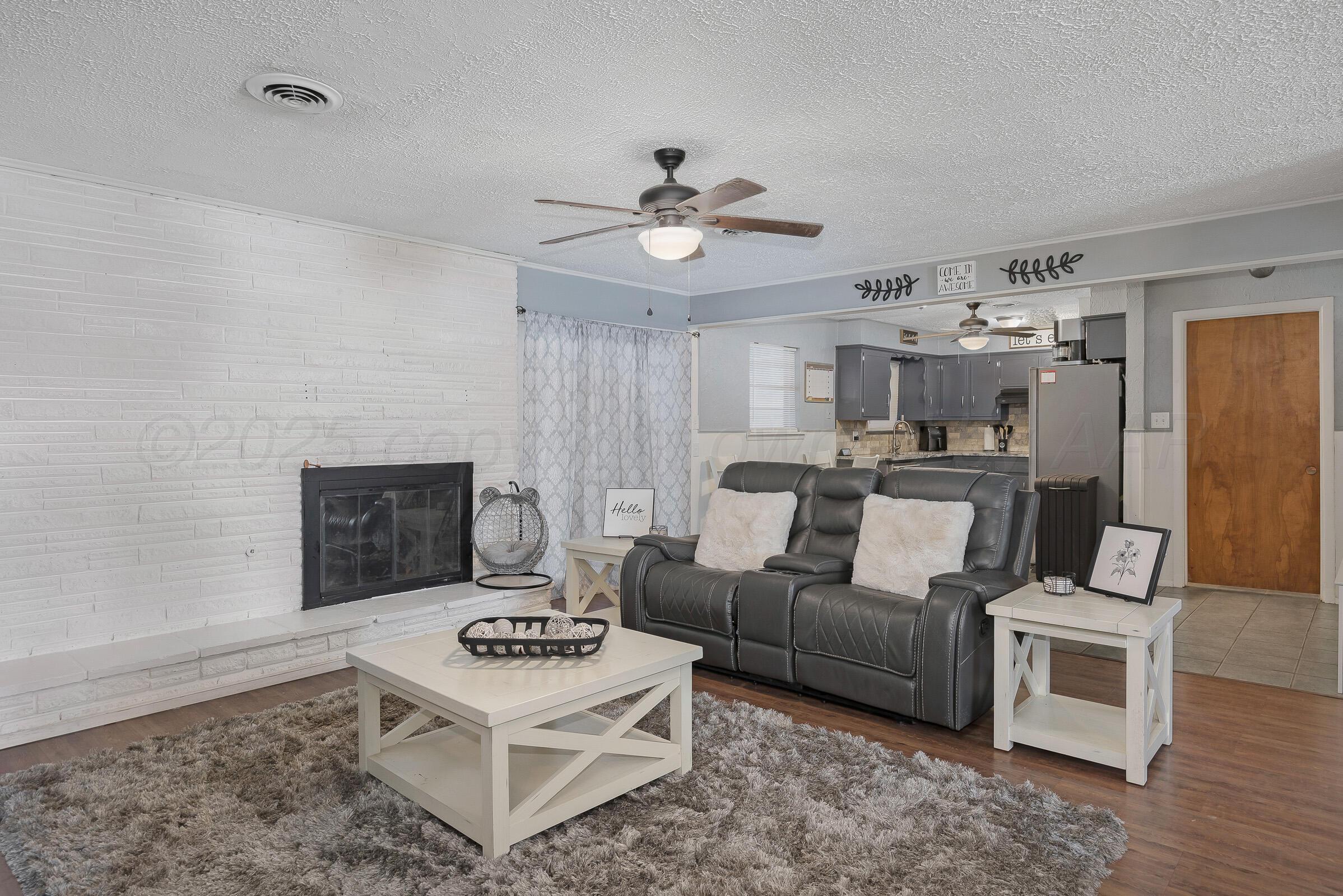 4020 Tulane Drive Amarillo, TX 79109 - Photo 5 of 23 a living room with furniture and a fireplace