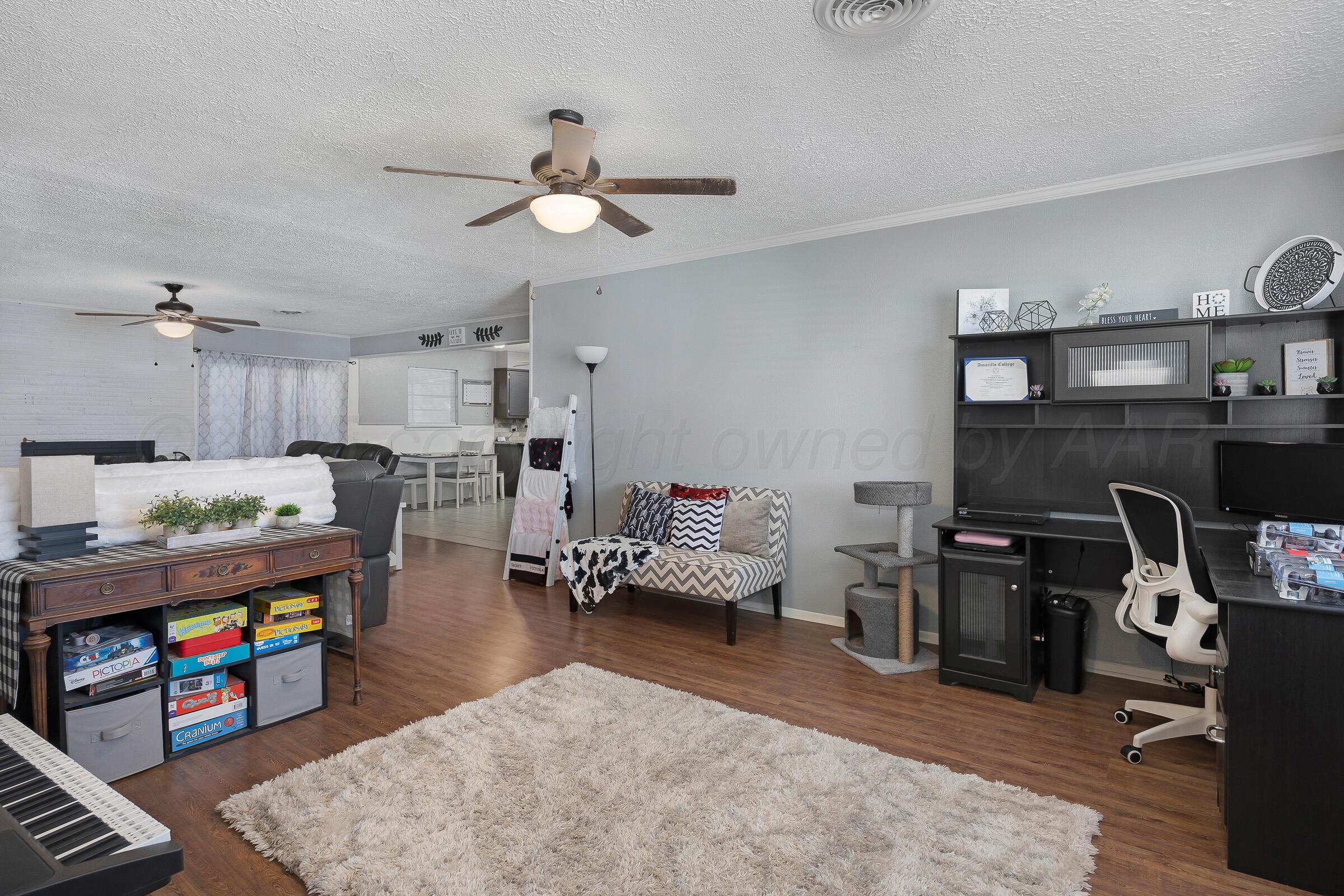 4020 Tulane Drive Amarillo, TX 79109 - Photo 6 of 23 a living room with furniture and wooden floor