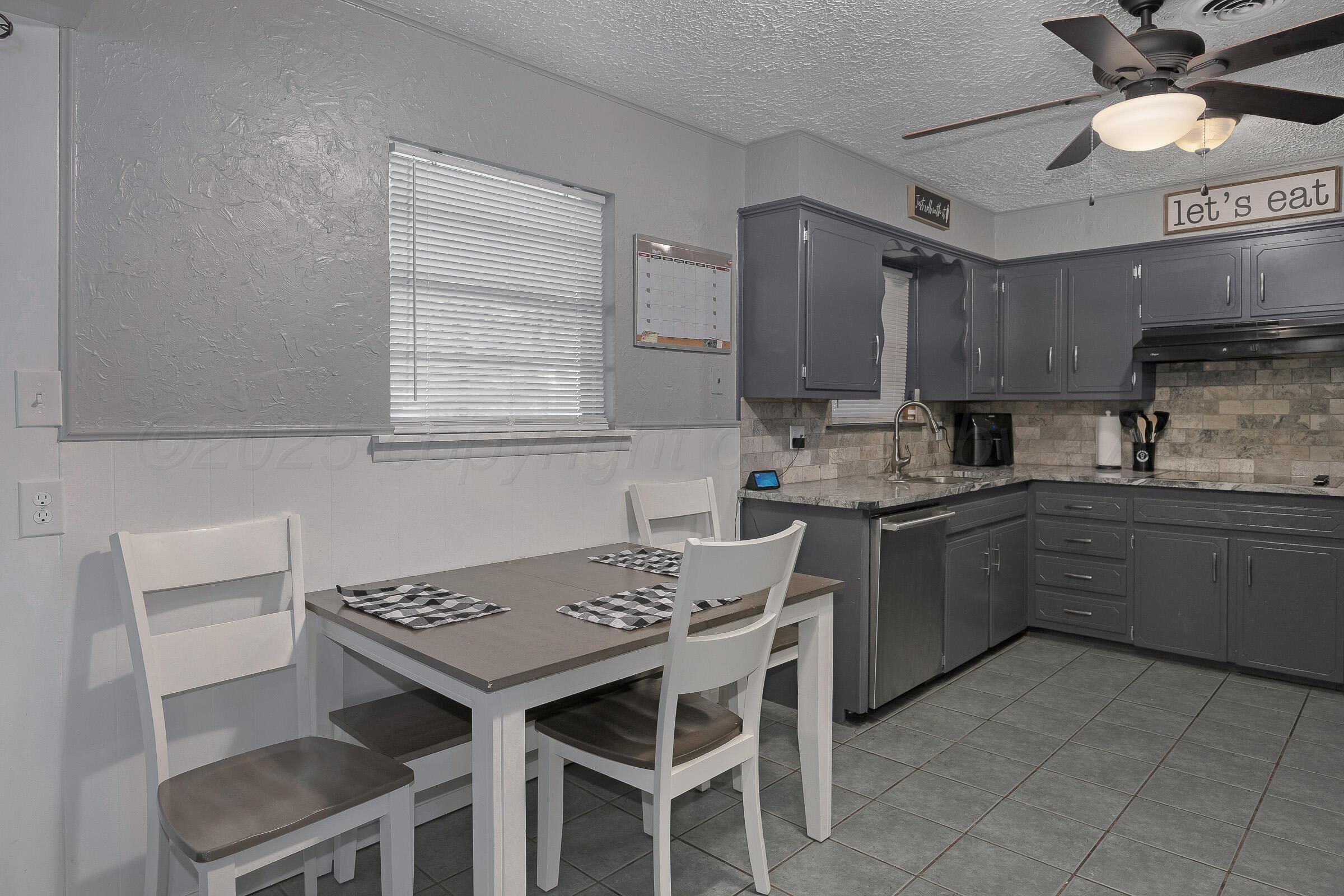 4020 Tulane Drive Amarillo, TX 79109 - Photo 8 of 23 a kitchen with a stove cabinets and a counter top space