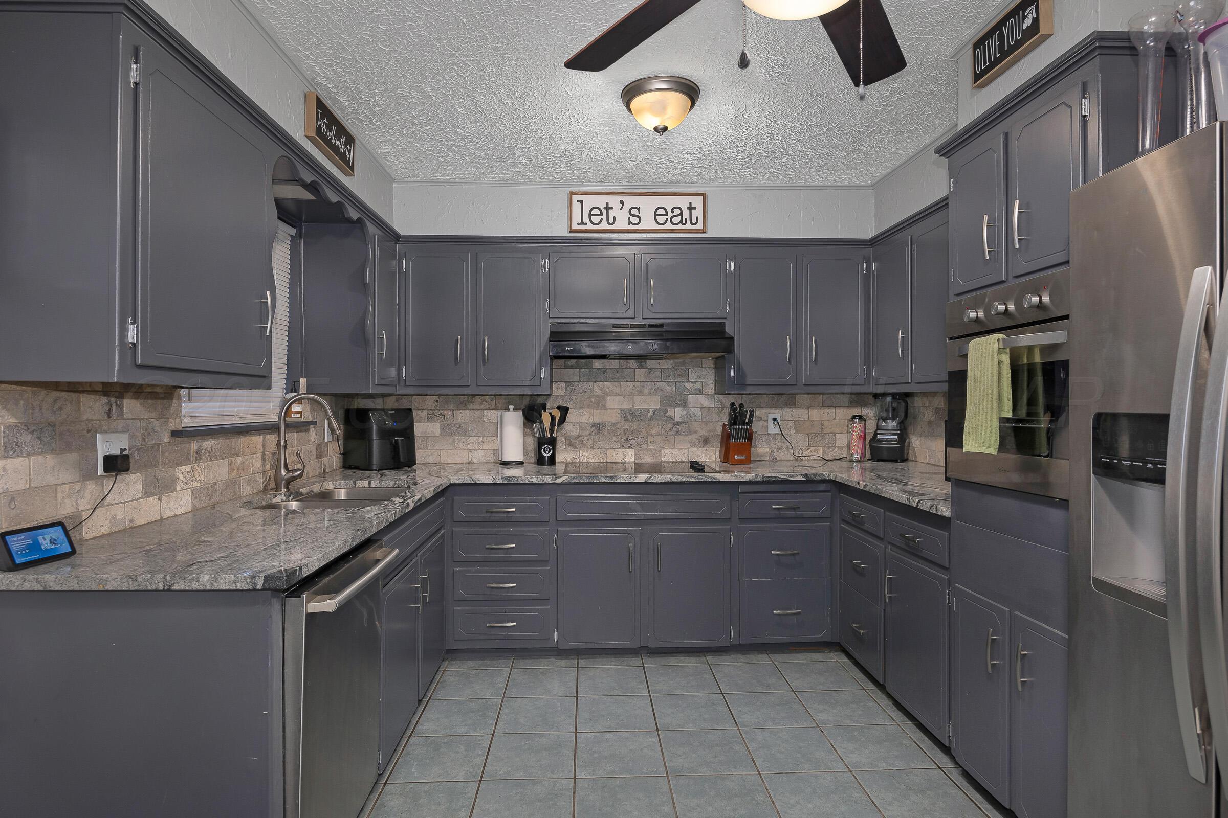 4020 Tulane Drive Amarillo, TX 79109 - Photo 9 of 23 a kitchen with stainless steel appliances granite countertop a sink and cabinets