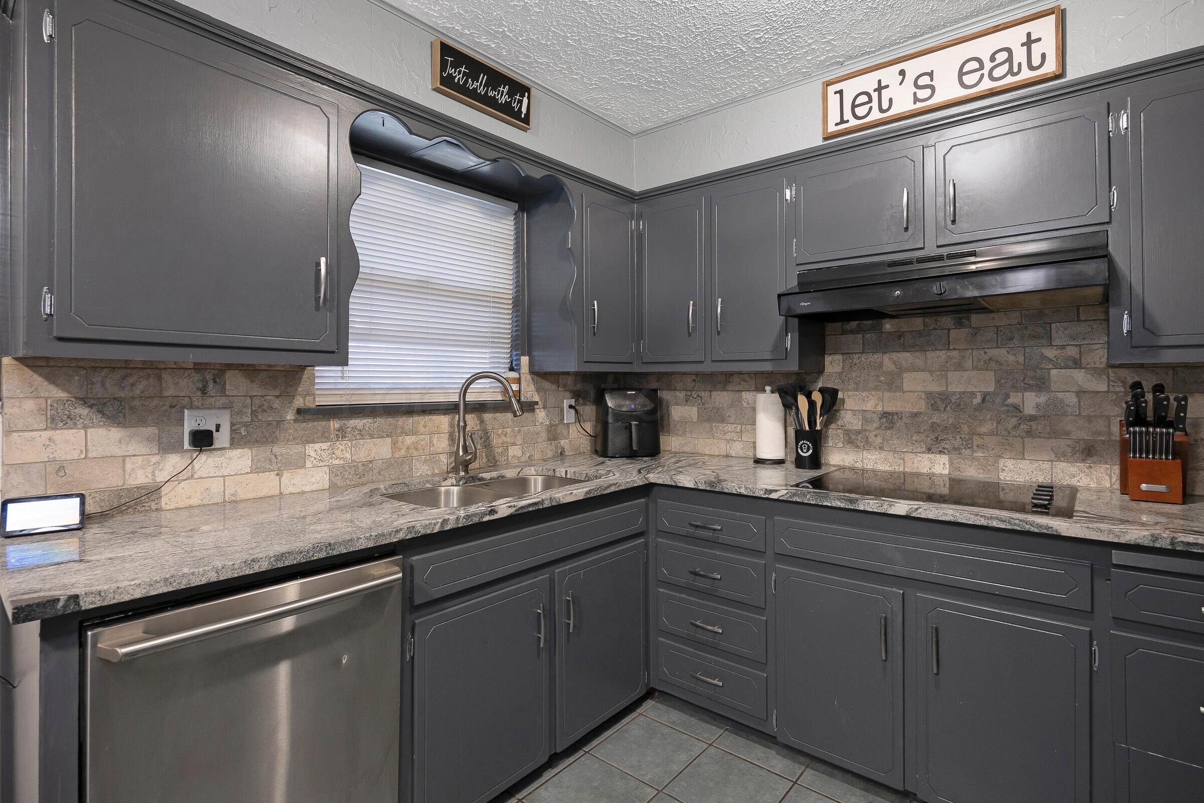 4020 Tulane Drive Amarillo, TX 79109 - Photo 10 of 23 a kitchen with stainless steel appliances granite countertop a sink a stove and cabinets