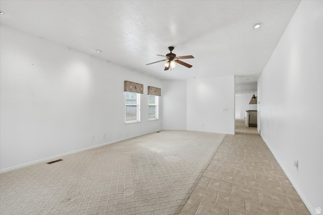 560 East 700 North Logan, UT 84321 - Photo 4 of 32 Spacious interior featuring a neutral color palette, recessed lighting, and a ceiling fan