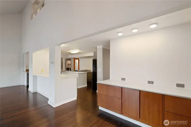 a kitchen with stainless steel appliances granite countertop a sink a stove and refrigerator