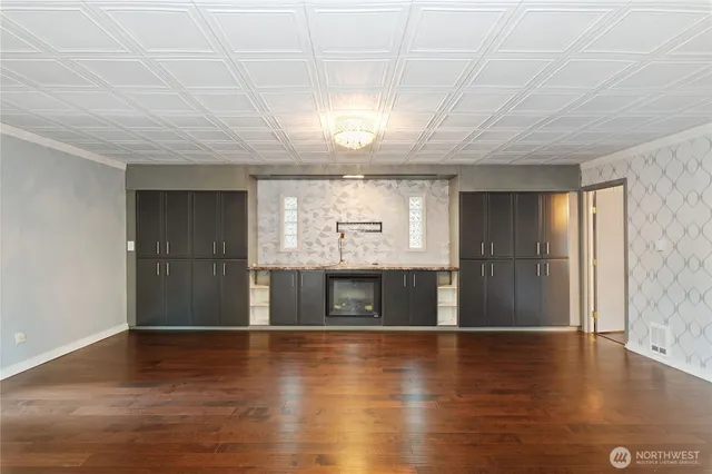 a large room with wooden floor and ceiling fan
