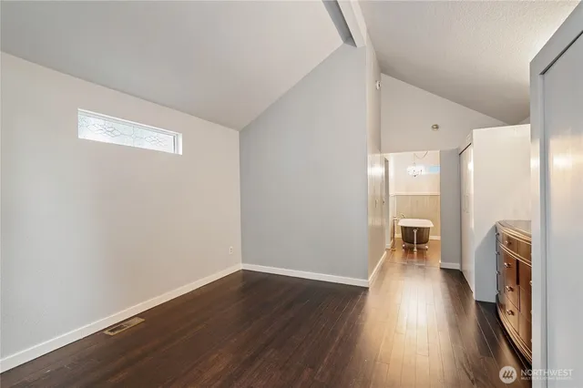 a room with a dresser and a window