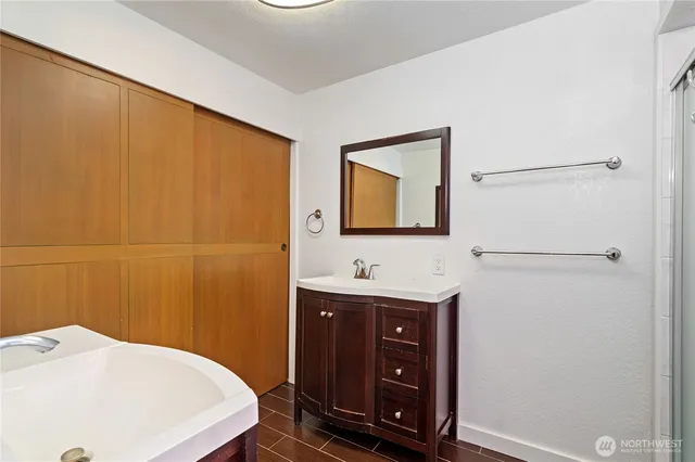 a en suite bathroom with a granite countertop sink toilet a mirror and shower