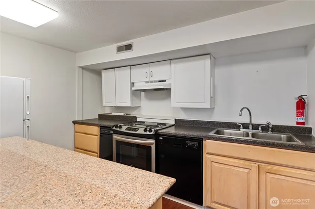 a utility room with cabinets washer and dryer