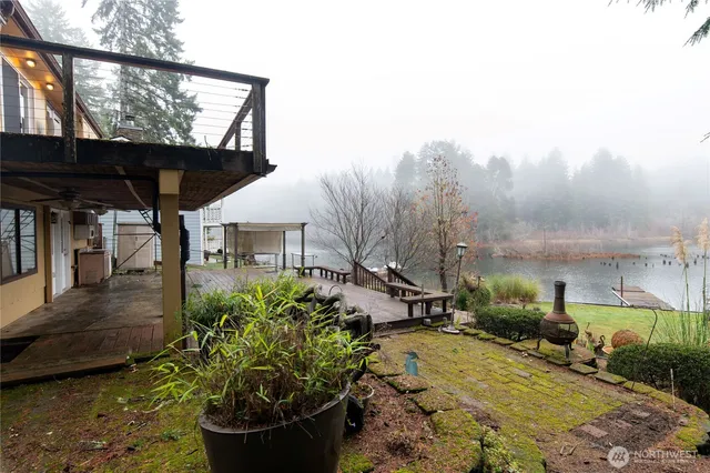 a view of a porch with furniture and a yard